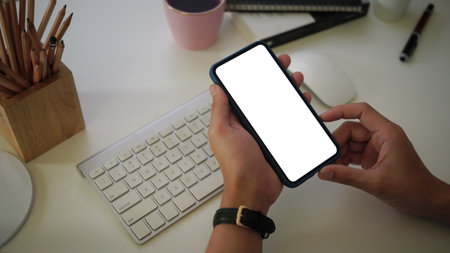 Above view of comfortable workplace with laptop computer, notebook, plant, sticky note and copy space. on wooden background.の写真素材