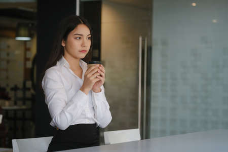 Attractive woman holding credit card and using computer tablet for online shopping or online payment transaction.の写真素材