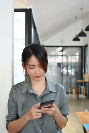 Portrait of happy young asian woman using digital tablet and holding credit card for online payment or online shopping.の写真素材