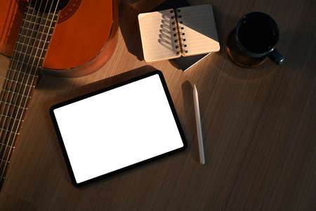 Digital tablet, stylus pen, notebook and coffee cup on yellow background.の写真素材