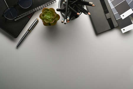 Female workplace with smart phone, glasses, notebook, wallet and stationery on white background.