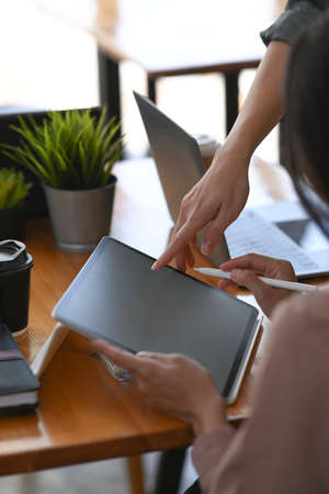 Cropped shot of two young designers co working on a new project in creative office.