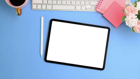 Above view of graphic designer workplace with laptop computer, color swatches, stationery and notebook on marble background.の写真素材