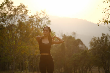 Fitness woman stretching after exercises outdoors in evening.の写真素材