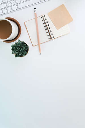 Overhead shot of woman holding mock up smart phone on orange background.の写真素材