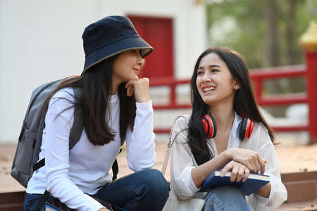 Asian college students having break after classes and talking each other in campus.の写真素材