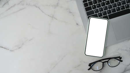 Top view of mock up digital tablet, stylus pen, notebook, coffee cup and sticky note on brown background.の写真素材