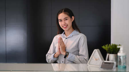 Portrait of businesswoman smiling and watching webinar on computer tablet in office.
