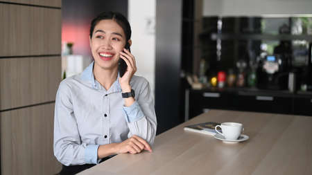 Portrait of businesswoman smiling and watching webinar on computer tablet in office.