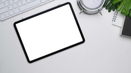 Hight view of businessman holding mobile pone with blank screen on white office desk.の写真素材