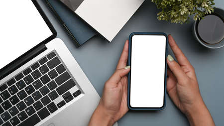 Top view of smart phone, laptop computer, notebook and coffe cup on pink background.の写真素材