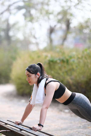 Sportswoman  in sportswear warming up before outdoor workout.の写真素材