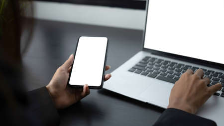Close up view of businesswoman holding stylus pen pointing on empty screen of computer tablet at her office desk.の写真素材