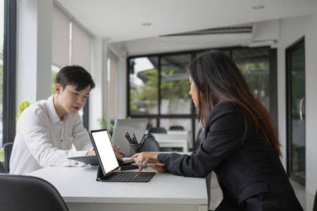 Young business people discussing business project issues together in office.の写真素材