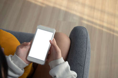 Above view of woman hands typing on keyboard over white office desk.の写真素材