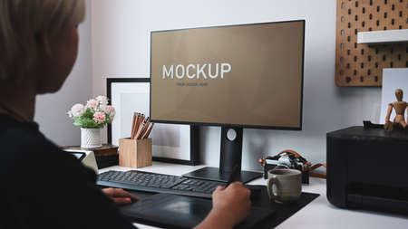 Side view of creative designer working with digital tablet in office.の写真素材