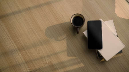 Modern workspace with computer laptop, coffee cup, notebook, smart phone and copy space on yellow...