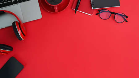 Top view workspace with empty screen of mobile phone and office supplies on white office desk.の写真素材