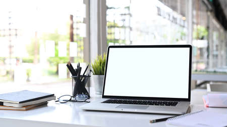 Mockup tablet and female accessories surrounded with coffee on white desk.