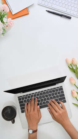 Stylish workspace with laptop computer, notebook and glasses on yellow background. Top view.の写真素材