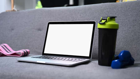Stylish workspace with laptop computer, notebook and glasses on yellow background. Top view.