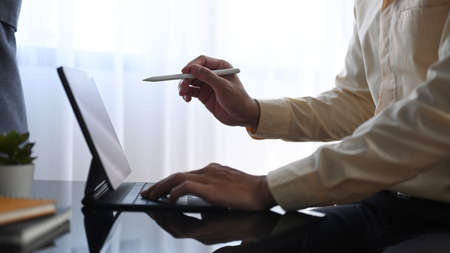 Portrait of calm businessman analyzing financial data at his office.