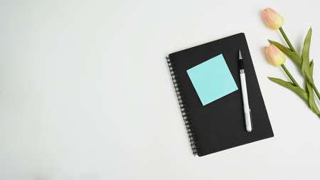 Digital tablet, cup of coffee, notebook and glasses on black leather. Top view with copy space, flay lay.の写真素材