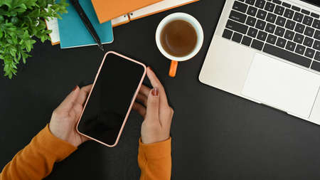 Smart phone with white screen, computer and tablet on wooden table.の写真素材