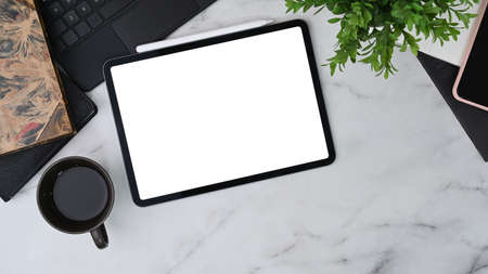 Mock up smart phone and computer tablet with white screen on wooden table.