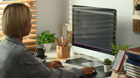 Cropped shot of young woman programmer working on project in software development company.