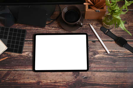 Mock up digital tablet, smart phone, headphone and notebook on brown leather.の写真素材