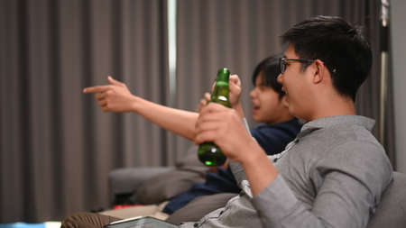 View over shoulder businesswoman holding pen and using smart phone at office.の写真素材