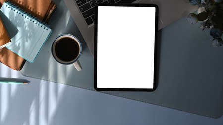 Top view computer laptop, smart phone, coffee cup and notebook on office desk.の写真素材