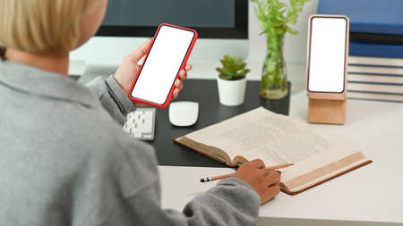 Cropped shot of stylish woman hands typing on wireless keyboard of digital tablet.