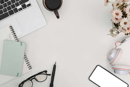 Top view office workspace with smart phone, glasses, notebook and coffee cup.の写真素材