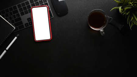 Modern dark workspace with black equipment and copy space on black leather.