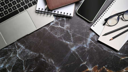 Wood office desk table with laptop, smart phone, coffee cup and supplies.の写真素材