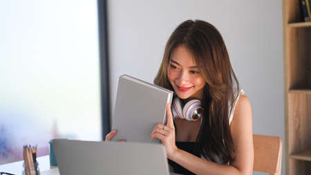 Confident young businesswoman concentrate working on laptop computer at her workplace.