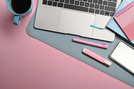 Mock up smart phone, notebook and coffee cup on woman workplace.の写真素材