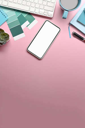 Mock up smart phone, notebook and coffee cup on woman workplace.の写真素材