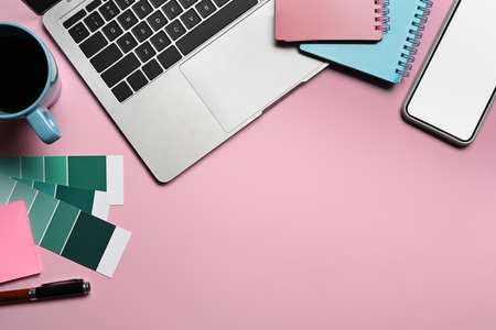 Smart phone, notebook and keyboard on graphic designer workspace.