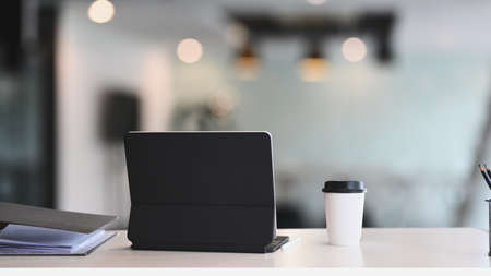 Mock up smart phone, notebook and coffee cup on woman workplace.