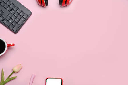 Headphone, keyboard, coffee cup and copy space on pink background.の写真素材