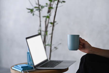 Top view smart phone, laptop, notebook, glasses and coffee cup on wooden background.
