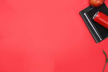 Creative workspace with empty notebook, pen, coffee cup and mobile phone on pink background.の写真素材