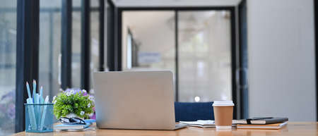 Accountant workplace with laptop computer, calculator and documents on wooden desk.の写真素材