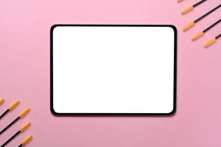 Laptop computer with white screen on wooden desk in modern office.の写真素材