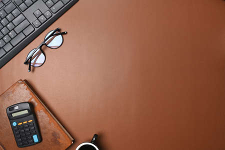 Man holding smart phone and reading information on notebook.の写真素材