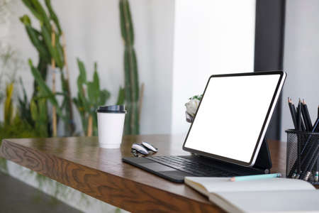 Stylish workplace with computer and orange accessories.の写真素材