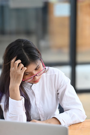 Businesswoman in protective mask analyzing business data at office.の写真素材